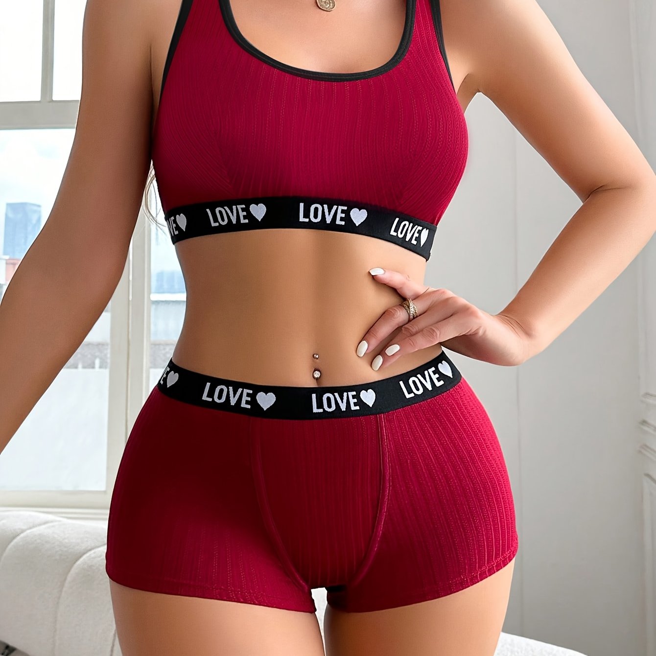 Athletic-inspired lingerie set for women featuring a tank bra and boyshorts with letter print and contrast trim.