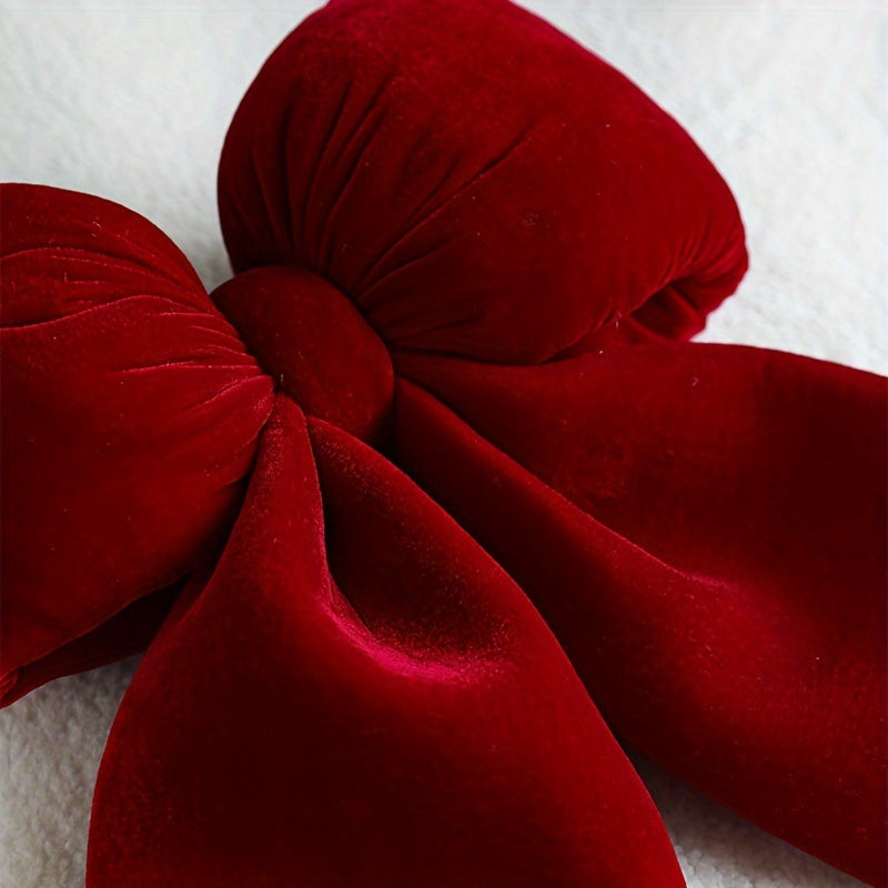 Christmas decorations include a handrail bow, fireplace bow, large velvet ornament bow, and red tree bow.