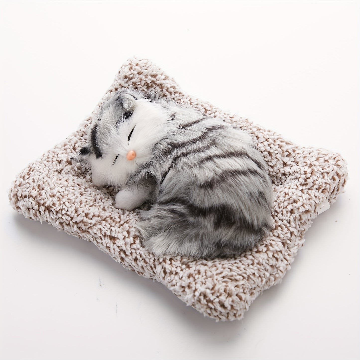 Fluffy sleeping cat figurine.