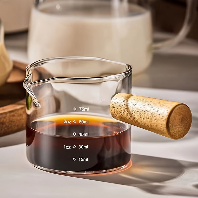 Small and stylish, this 2oz measuring cup features a heat-resistant glass body and a convenient wooden handle for easy use. With dual spout, scale markings, and ideal for measuring small quantities, this cup is perfect for both coffee and kitchen use.