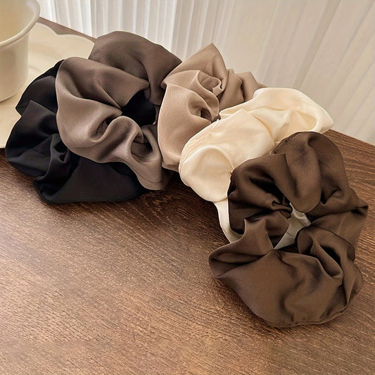 5 elegant and versatile hair scrunchies in classic black, white, and brown suited for all ages.