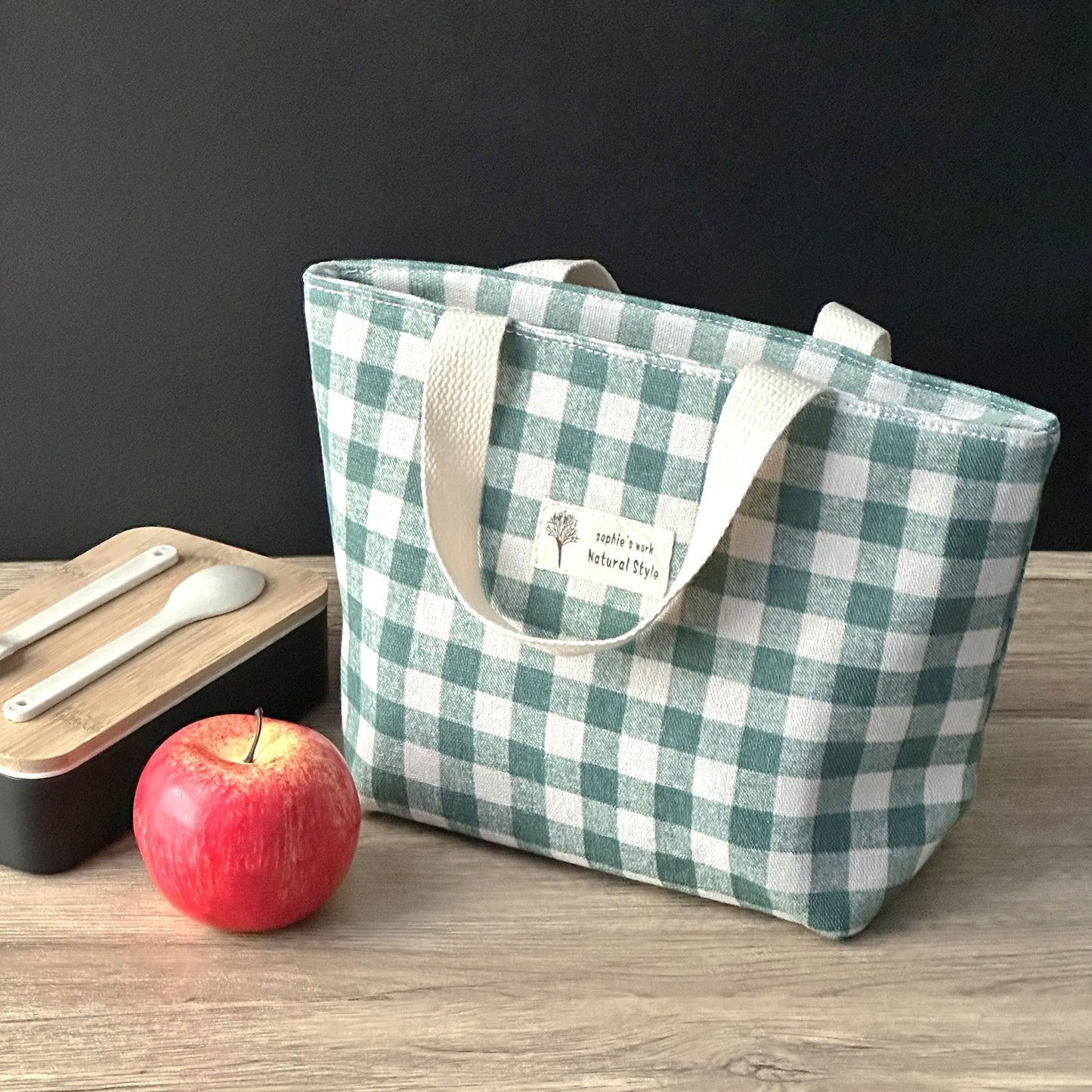 Stay organized and stylish with our plaid insulated lunch bag, made from durable materials to keep your items safe and secure. Available in classic color combinations of black and white, blue and white, and green and white, this lunch bag is versatile