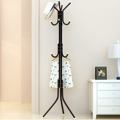 Multi-purpose, freestanding black metal coat rack with tree-style design for hanging clothes and hats in the bedroom.