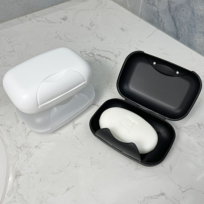 Travel-friendly plastic soap dish with lid, for convenient soap storage in the bathroom.