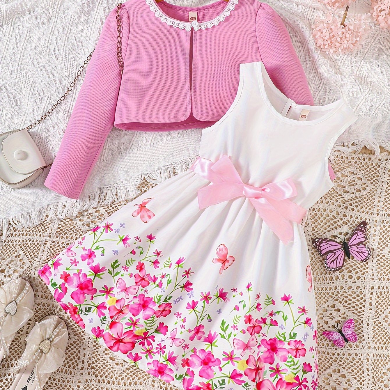 Girls' spring fashion 2-piece set includes floral print dress with belt detail and matching cardigan. Made of 100% polyester, non-stretch woven fabric. Perfect for outdoor wear.