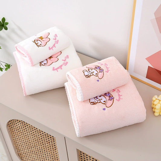 Contemporary cartoon-themed Hello Kitty and Friends plush bath towels in knit fabric made from a 40% cotton, 60% acrylic blend. Featuring a checkered pattern, low lint, 280gsm, and oblong shape, ideal for wash cloths.