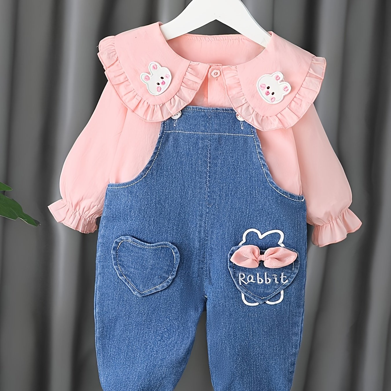 Baby girl's 2-piece denim overalls with rabbit embroidery plus ruffled blouse for spring and fall outdoor wear.