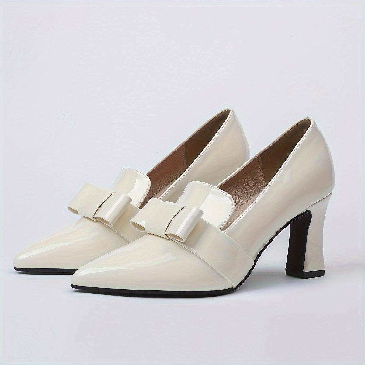 Women's elegant solid color pumps with bowknot design, block heel and waterproof features.