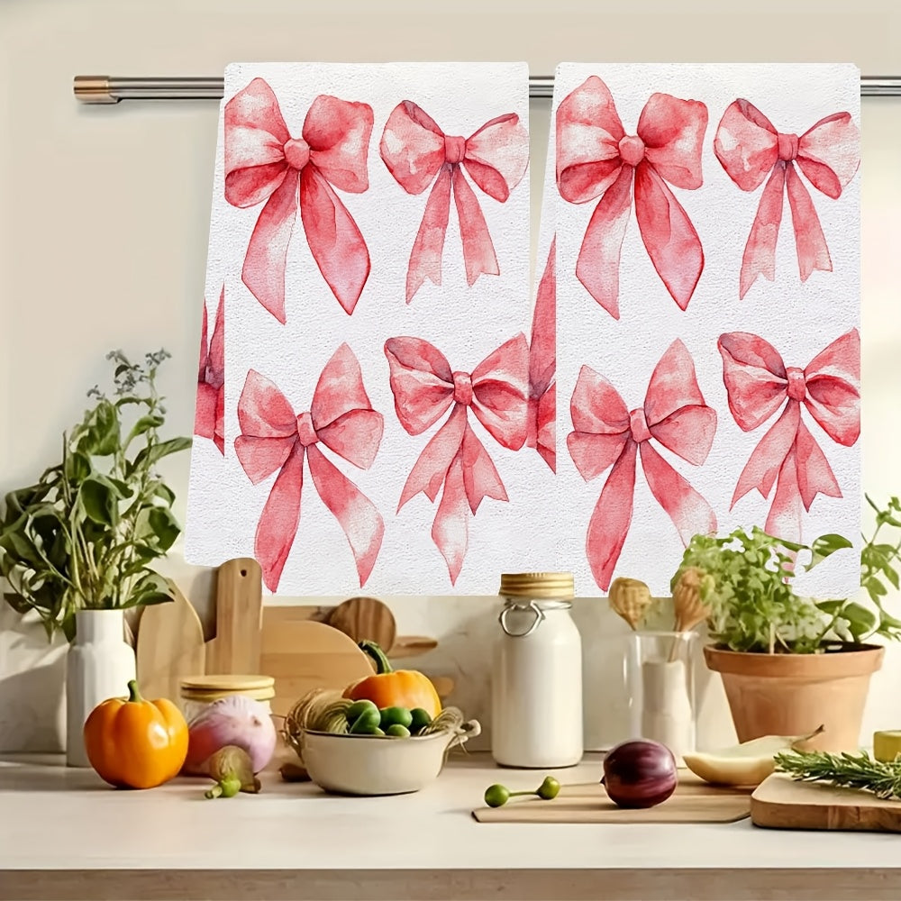 Two ultra soft kitchen towels featuring a Valentine's Day bows design. These towels are highly absorbent, machine washable, and measure 40.64x60.96 cm. The contemporary red bow pattern is perfect for holiday decor.