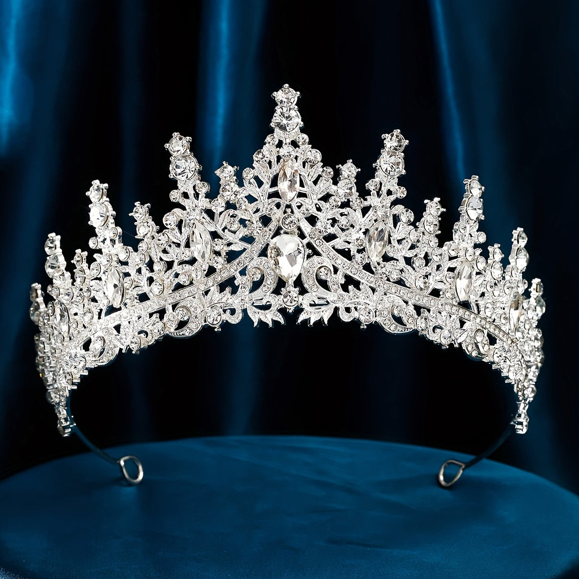 Silver alloy rhinestone tiara for elegant weddings and parties.